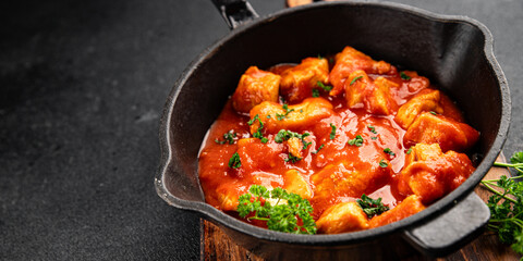 Butter chicken curry poultry meat tomato sauce dish fresh tasty gourmet food background on the...