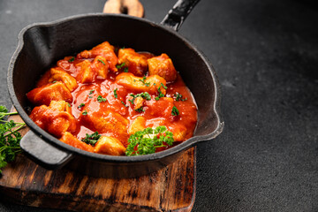 Butter chicken curry poultry meat tomato sauce dish fresh tasty gourmet food background on the table rustic food top view copy space