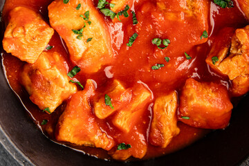 Butter chicken curry poultry meat tomato sauce dish fresh tasty gourmet food background on the table rustic food top view copy space