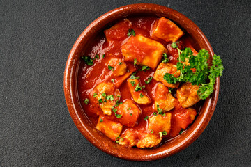 Butter chicken curry poultry meat tomato sauce dish fresh tasty gourmet food background on the table rustic food top view copy space