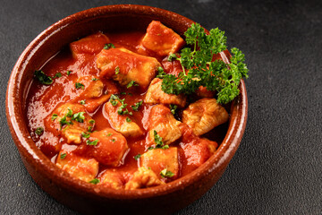 Butter chicken curry poultry meat tomato sauce dish fresh tasty gourmet food background on the table rustic food top view copy space