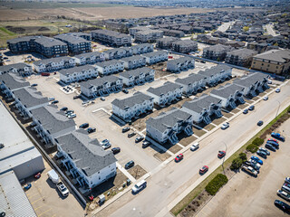 Residential area with many houses and cars parked on the street