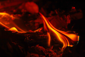 soft focus photo of beautiful fire flames with reflection on dark background.
