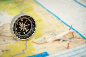 selective focus of compass on blurred map background.