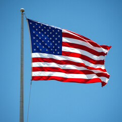 Obraz premium American flag waving proudly against a clear blue sky during midday in a park setting