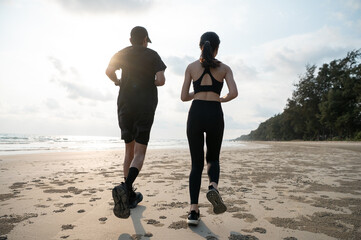 Young men and women run along the sea or beach to promote health, strength and quality of life, emphasizing the concept of fitness, sports and having a healthy lifestyle for both young and old people.