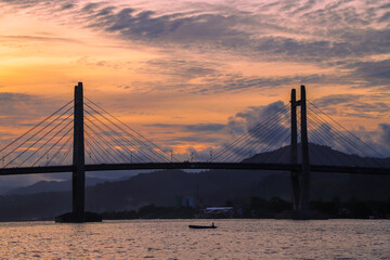 Obraz premium Sunset View Iconic Merah Putih Cable Stayed Bridge accross Ambon Bay and Wai Ruhu Galala Yellow Truss Bridge