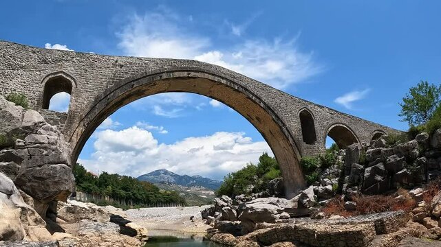 A view of the Ottoman Mesi Bridge near Shkoder in northwestern Albania. Mesi bridge with tourists 