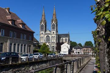 View across the Vie River towards Our Lady's Church (Notre Dame) in Vimoutiers, in Orne, Normandy, France, on a sunny spring day. With copy space.