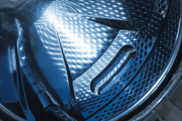 Reflective stainless steel interior of a washing machine drum