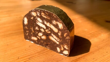 Rich mosaic-patterned chocolate salami, an indulgent delight for festive tables, conjures Easter...