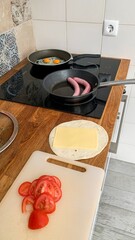 Sizzling sausages and vibrant breakfast spread herald Pancake Day's dawn, invoking Hygge's cozy...