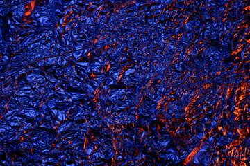 Red and blue Shiny aluminum foil texture close up
