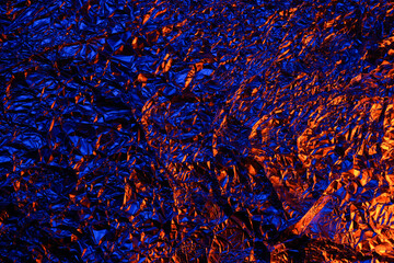 Red and blue Shiny aluminum foil texture close up