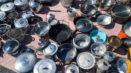Vintage pots and pans symphony sparkle under the sun, echoing kitchen tales, reminiscent of...