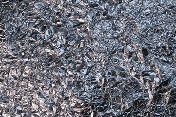 The texture of shiny aluminum foil close up