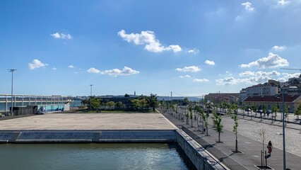 Urban riverside whispers to azure skies, ideal for contemplative promenades on Dia de Sao Joao,...
