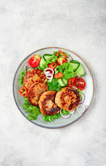 fried chicken cutlets, minced chicken, with vegetables, on gray , with vegetable salad, top view, homemade, no people,