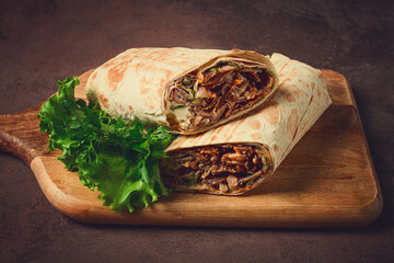 cut shawarma, 2 pieces, on a cutting board, close-up,