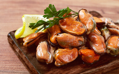 mussels without shell, boiled, mussels, peeled, on a chopping board, with lemon and parsley,...