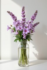 Vibrant Purple Flower Bouquet in Clear Vase on Bright Background