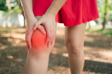 A woman is hurting her knee after running. Health problem concept, osteoarthritis problem. Running hard until injured..