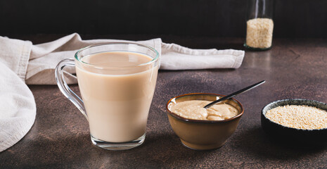 Tahini latte with sesame spread in a cup on the table web banner