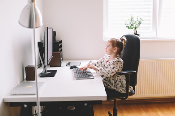 Little girl typing on computer