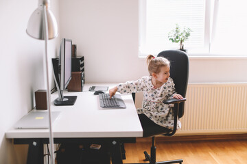 Little girl working on the desk