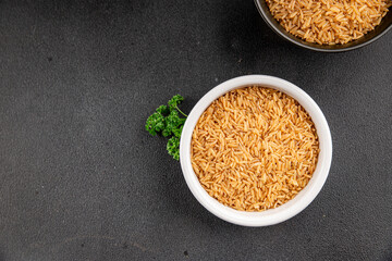 Brown rice whole grain cereal healthy product superfood fresh tasty gourmet food background on the table rustic food top view copy space keto and paleo diet vegetarian and vegan food