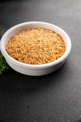 Brown rice whole grain cereal healthy product superfood fresh tasty gourmet food background on the table rustic food top view copy space keto and paleo diet vegetarian and vegan food
