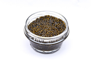 Black caviar in glass jar isolated on white background.