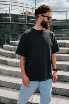 Bearded hipster in black t-shirt and sunglasses &mdash; urban mockup for brands