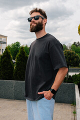 Bearded hipster in black t-shirt and sunglasses — urban mockup for brands