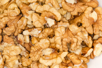 Heap of seed kernels of walnuts, top view close-up