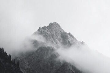close-up of mountain peak enveloped in misty clouds
