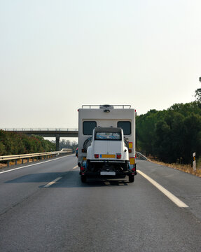 camper towing a citroen 2cv6 club on the highway 22 Sep 2024 San Juan Spain