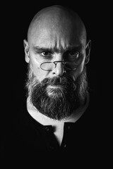 Black and white portrait, emotional bearded man in glasses, grimacing and grimacing at the camera....