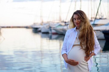 Pregnant woman posing at the port of Golfe Juan, France