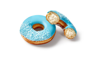 Two tasty blue donuts with coconut flakes and cream filling resting on white background