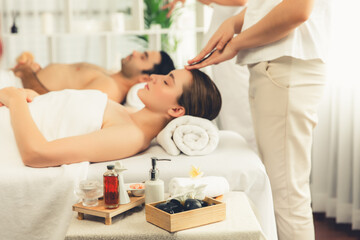 Caucasian couple enjoying relaxing anti-stress head massage and pampering facial beauty skin...