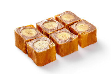 Sweet banana sushi rolls with chocolate cream filling on white background