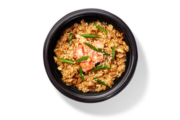 Wok rice with shrimps, eggs and sesame seeds in black bowl