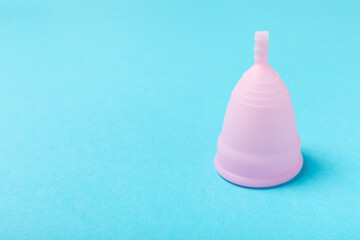 Menstrual cup on a bright background. Sanitary napkins, tampons and menstrual cup.Concept of...