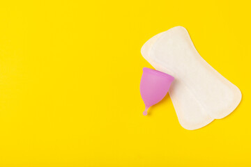 Menstrual cup on a bright background. Sanitary napkins, tampons and menstrual cup.Concept of...
