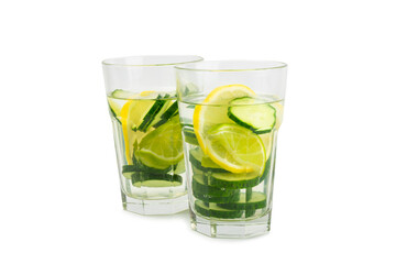 Cucumber water with lemon, lime and mint isolated on white background. Water infused with sliced ​​cucumber in a drinking glass. Tonic refreshing drink. Cucumber lemonade.Summer natural cooling drink