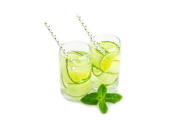 Cucumber water with lemon, lime and mint isolated on white background. Water infused with sliced ​​cucumber in a drinking glass. Tonic refreshing drink. Cucumber lemonade.Summer natural cooling drink