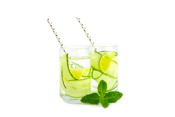 Cucumber water with lemon, lime and mint isolated on white background. Water infused with sliced ​​cucumber in a drinking glass. Tonic refreshing drink. Cucumber lemonade.Summer natural cooling drink