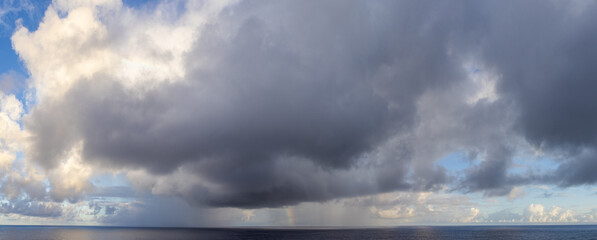 Dramatic Cloudscape Over the Pacific Ocean with a Hint of a Rainbow