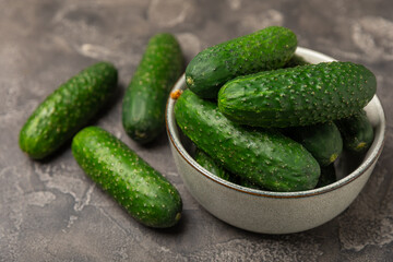 Cucumber on wooden background. Slice of cucumber on background. Fresh organic green cucumbers gherkin. Vegan. Salad ingredient. Farm vegetables. Cut vegetables with knife. Space for text. Copy space